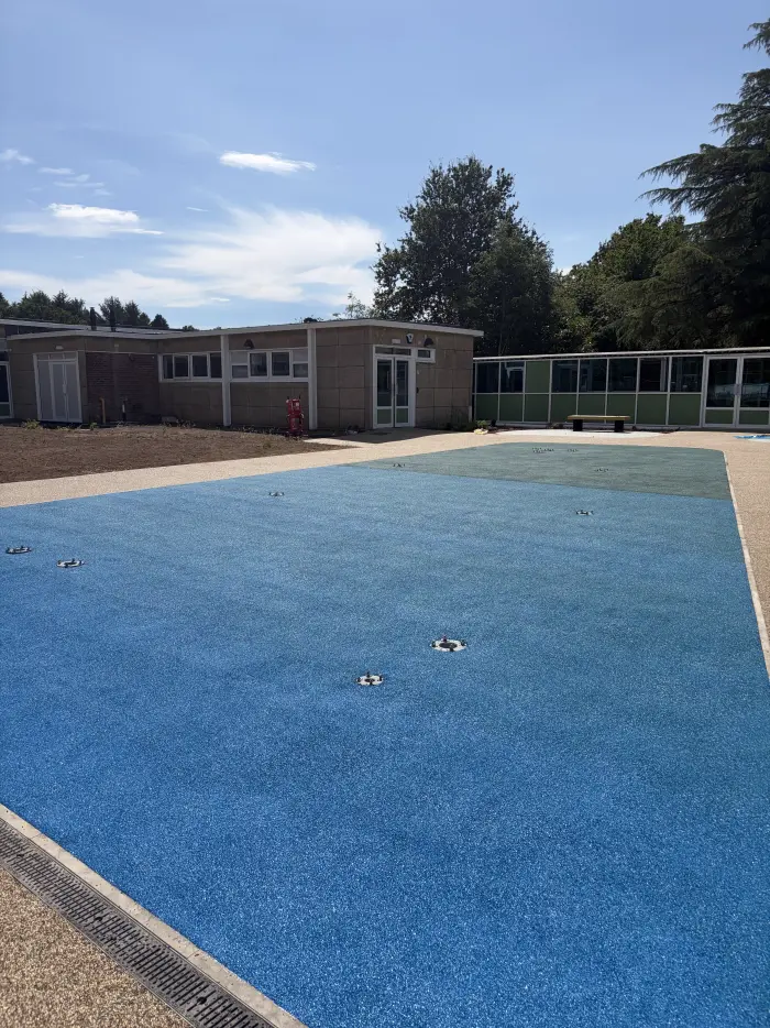 Blue rubber EPDM play surfacing with resin bound path border, by A&P Resin