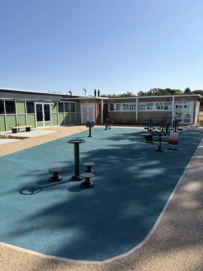 Blue rubber EPDM wet pour playground with play equipment, by A&P Resin