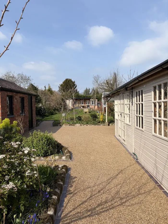 Golden resin bound path leading to a garden summerhouse, by A&P Resin