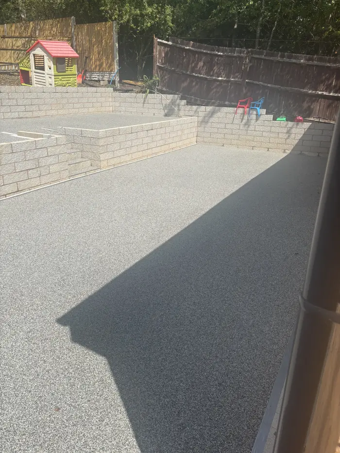 Grey resin bound patio in a walled garden, by A&P Resin