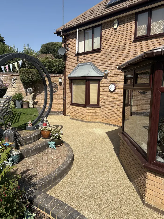 Resin bound patio wrapping around a detached house, by A&P Resin
