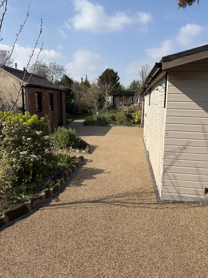 Golden resin bound path to a garden summerhouse, by A&P Resin