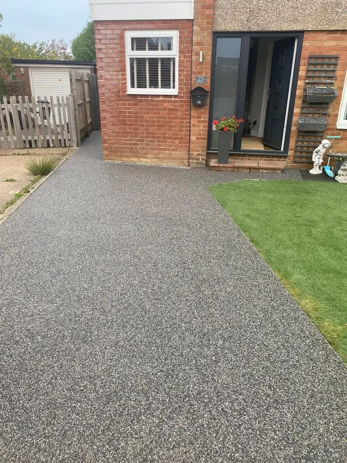 Grey resin bound driveway to a detached house, by A&P Resin
