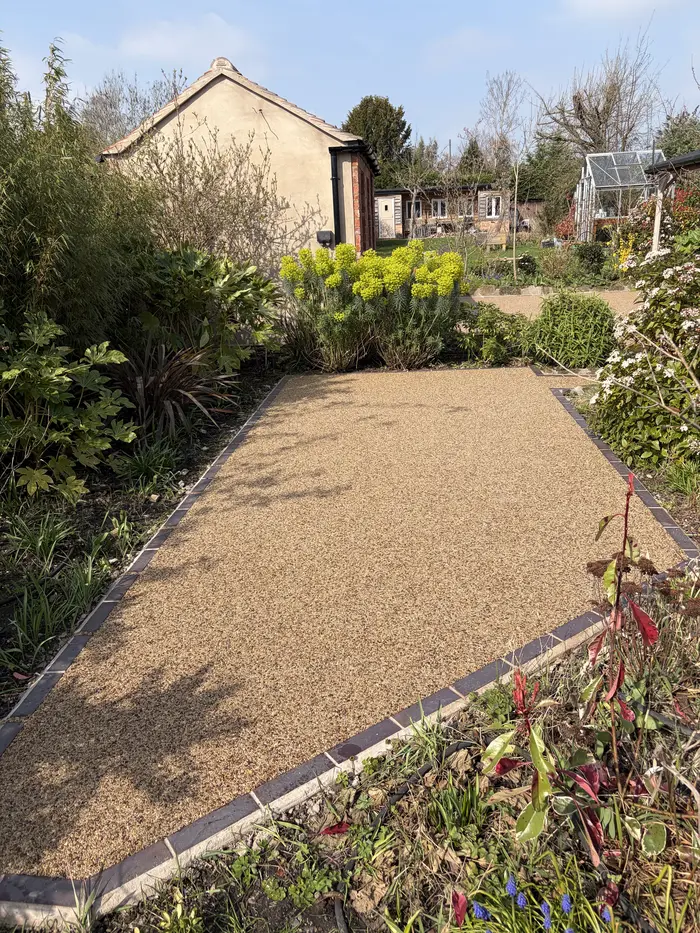 Golden resin bound garden path between flower beds, by A&P Resin