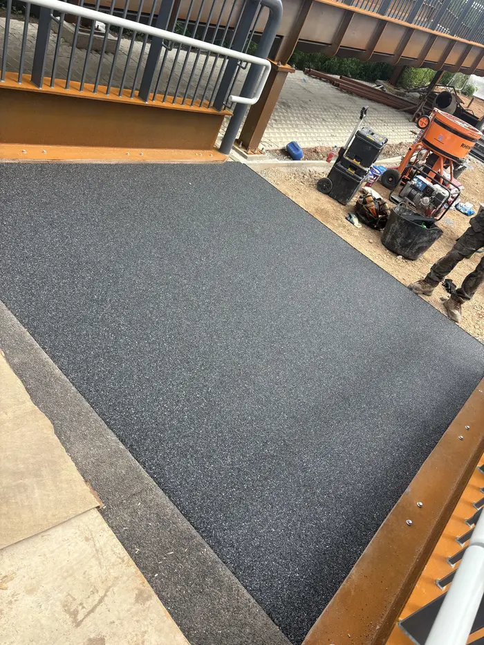 Black resin bound ramp surface under a canopy, by A&P Resin